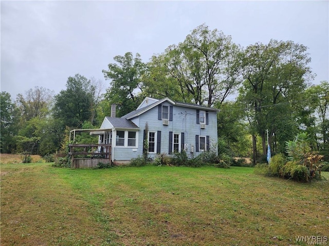 view of front facade featuring a front lawn and a wooden deck