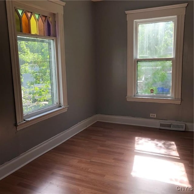 spare room with dark hardwood / wood-style flooring