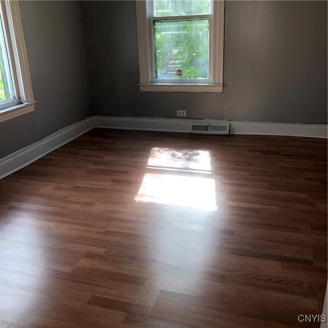 unfurnished room featuring dark wood-type flooring