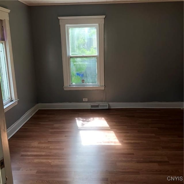 empty room with dark wood-type flooring