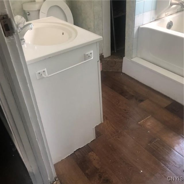 bathroom featuring vanity, toilet, and wood-type flooring