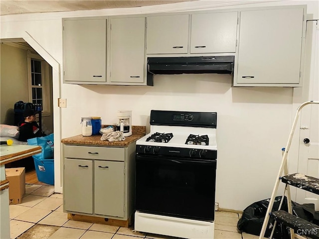 kitchen featuring light tile patterned floors and white range with gas stovetop