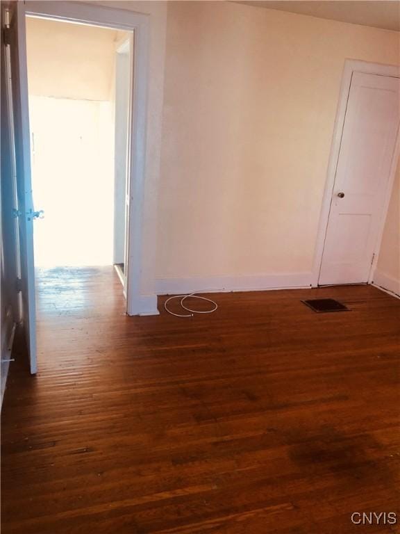 spare room with dark hardwood / wood-style flooring