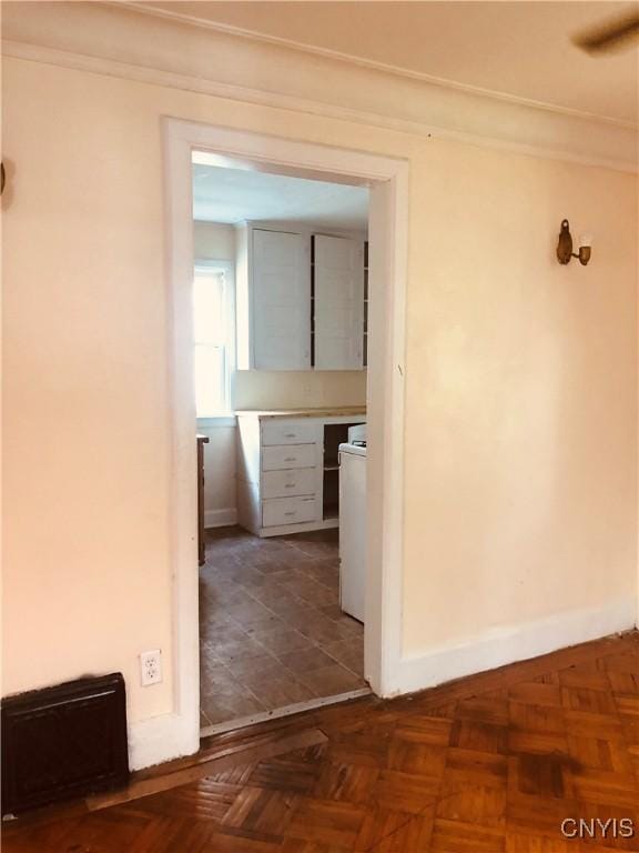 corridor featuring dark parquet floors and washer / clothes dryer