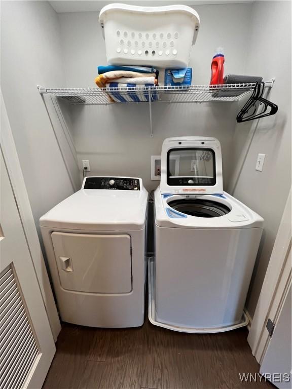 8977 Iroquois St, Evans, NY 14006 - laundry room with dark hardwood / wood-style flooring and washing machine and clothes dryer