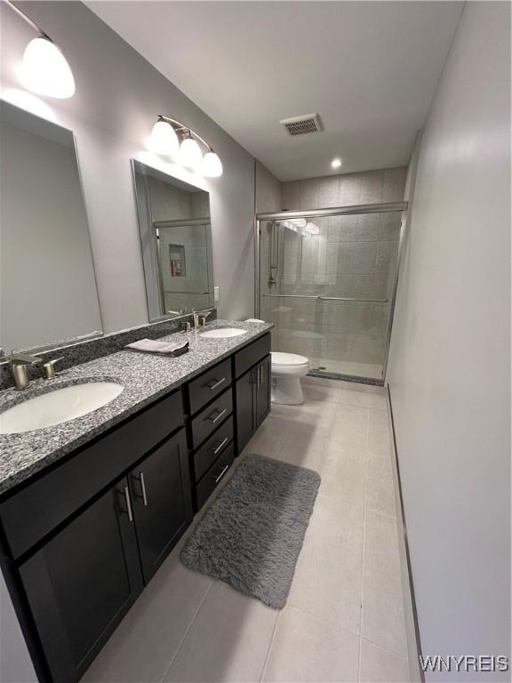 8977 Iroquois St, Evans, NY 14006 - bathroom with vanity, an enclosed shower, tile patterned floors, and toilet