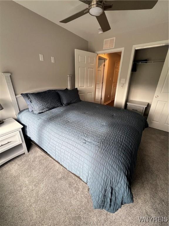 8977 Iroquois St, Evans, NY 14006 - bedroom featuring carpet, ceiling fan, and a closet