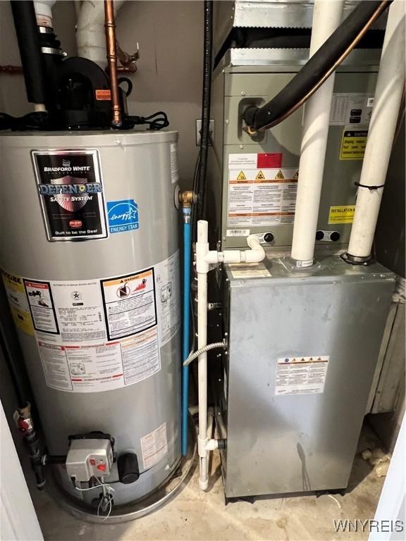8977 Iroquois St, Evans, NY 14006 - utility room featuring heating unit and gas water heater