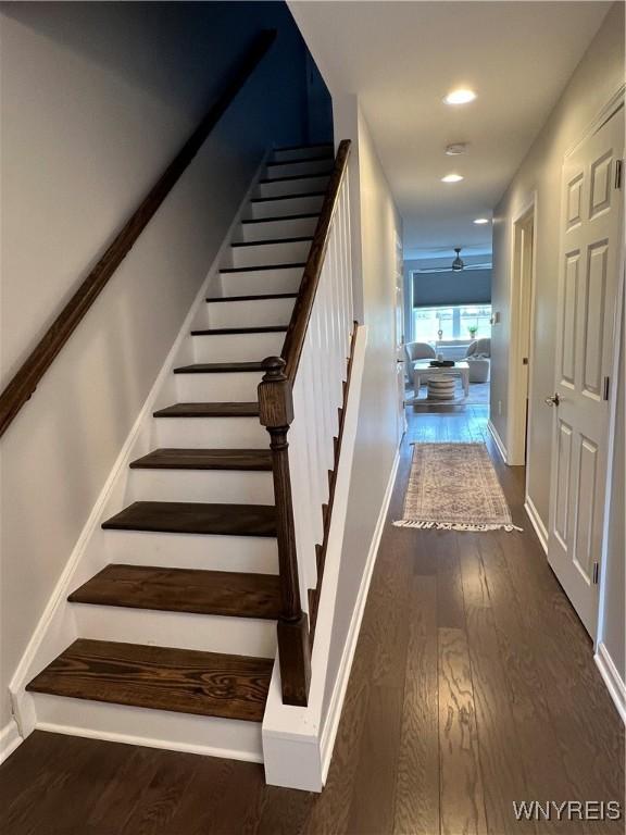 8977 Iroquois St, Evans, NY 14006 - stairs featuring ceiling fan and wood-type flooring