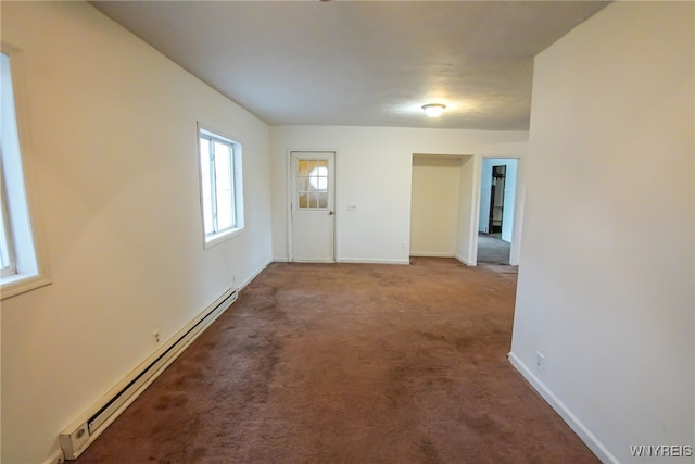 foyer entrance featuring carpet and a baseboard heating unit