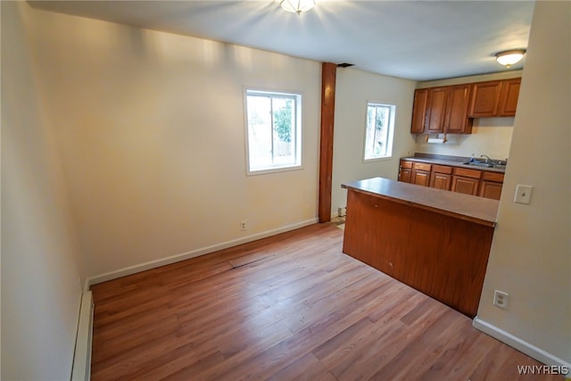 kitchen featuring a baseboard radiator and light hardwood / wood-style flooring