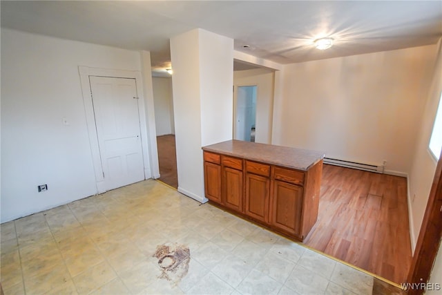 kitchen with kitchen peninsula and a baseboard radiator