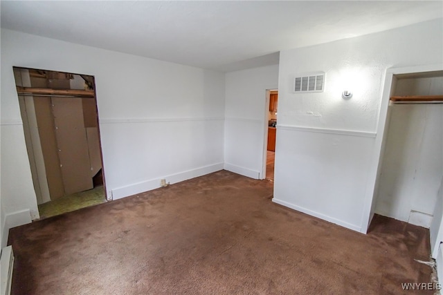 unfurnished bedroom with dark colored carpet