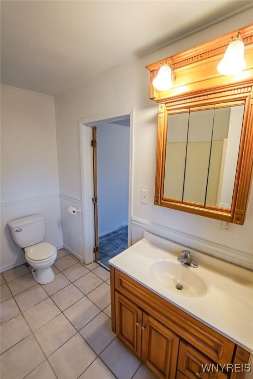 bathroom featuring tile patterned flooring, vanity, and toilet