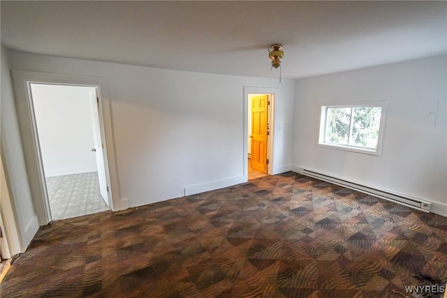 unfurnished room with a baseboard radiator