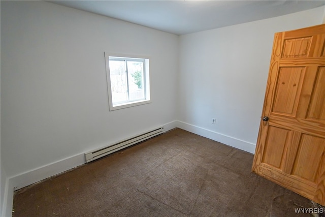 carpeted empty room featuring baseboard heating