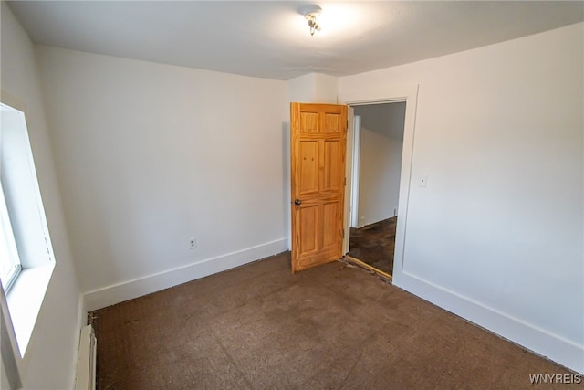 empty room with dark carpet