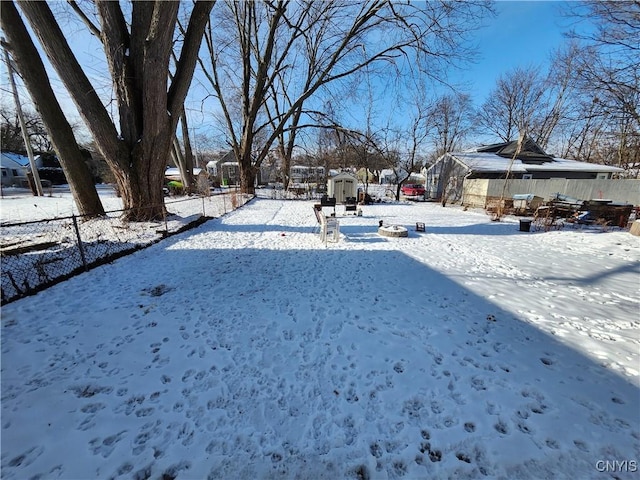 snowy yard with a storage unit