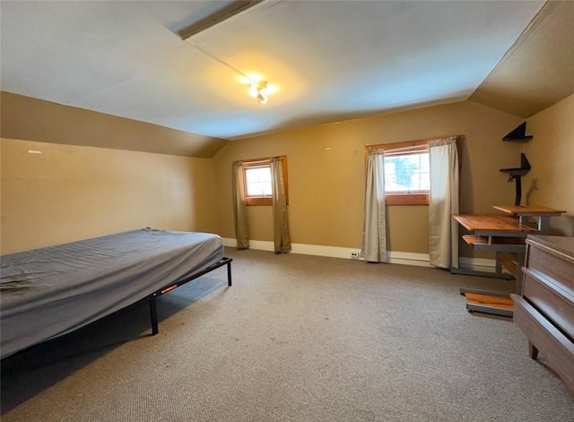 bedroom featuring carpet floors and vaulted ceiling