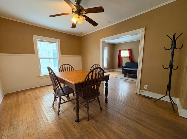 dining area with hardwood / wood-style floors, ceiling fan, and ornamental molding