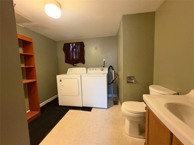 bathroom with washer and dryer, toilet, and vanity