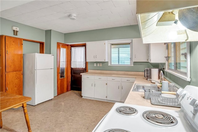 kitchen with sink, white cabinets, white appliances, and range hood