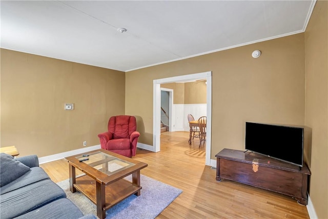 living room featuring ornamental molding and light hardwood / wood-style floors