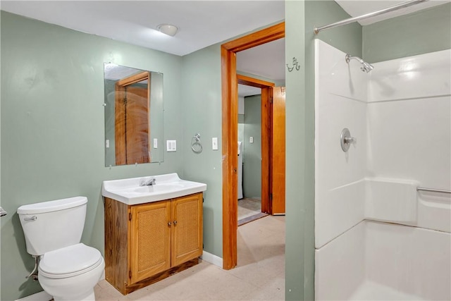 bathroom with walk in shower, vanity, and toilet