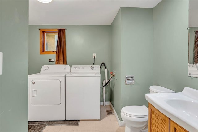 bathroom with separate washer and dryer, vanity, and toilet