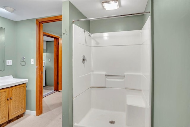 bathroom featuring vanity and a shower