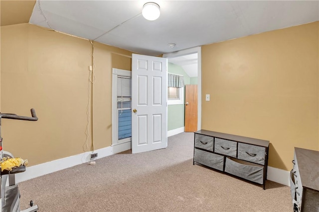 interior space featuring lofted ceiling and carpet floors