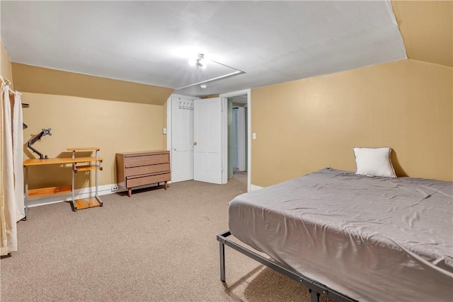 carpeted bedroom with lofted ceiling