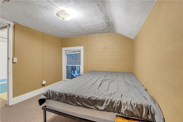 bedroom featuring lofted ceiling, carpet, and a textured ceiling