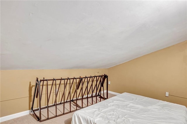 bedroom featuring vaulted ceiling and carpet floors