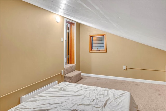 carpeted bedroom with vaulted ceiling