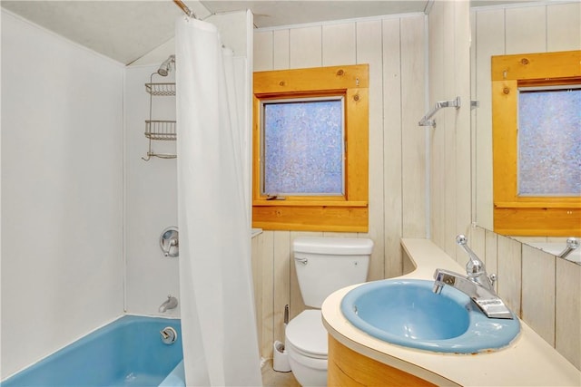 full bathroom featuring wood walls, vanity, toilet, and shower / bath combo