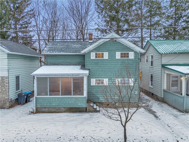 view of snow covered back of property