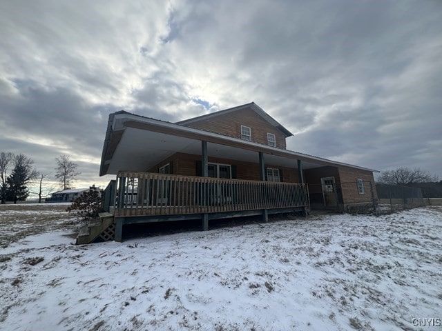 view of snow covered rear of property