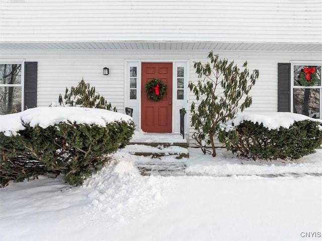 view of snow covered property entrance