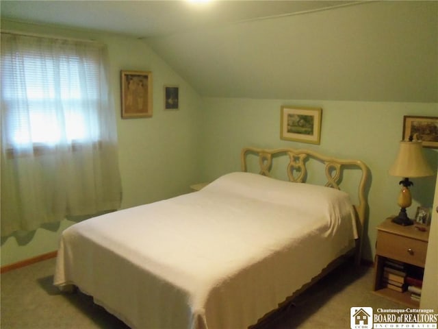 carpeted bedroom with vaulted ceiling