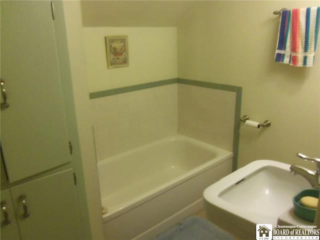 bathroom with a washtub and sink