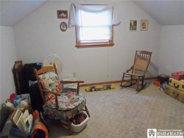 living area with carpet and vaulted ceiling