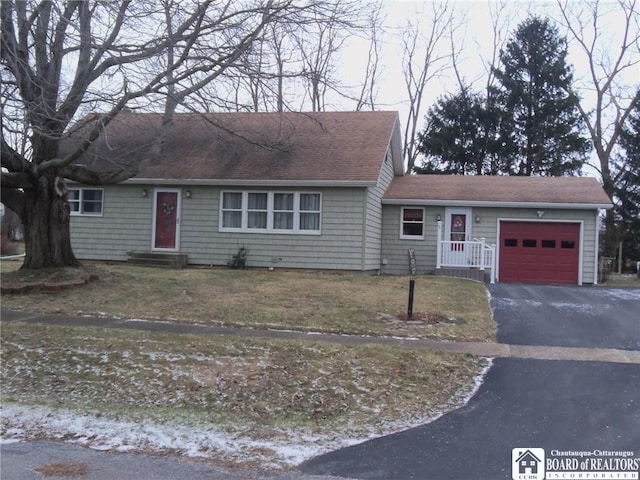 single story home with a garage and a front lawn