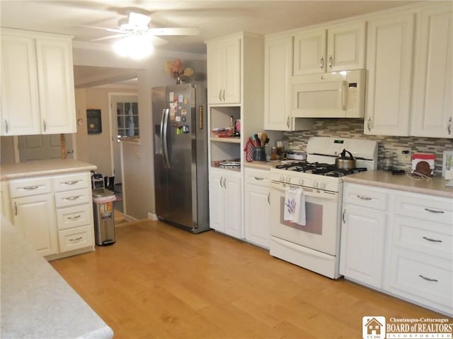 kitchen with white cabinets, ceiling fan, white appliances, and tasteful backsplash