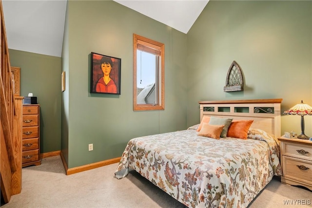 carpeted bedroom with lofted ceiling