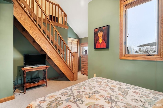 carpeted bedroom featuring vaulted ceiling and a closet