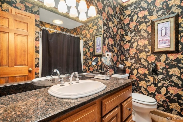 bathroom featuring vanity and toilet