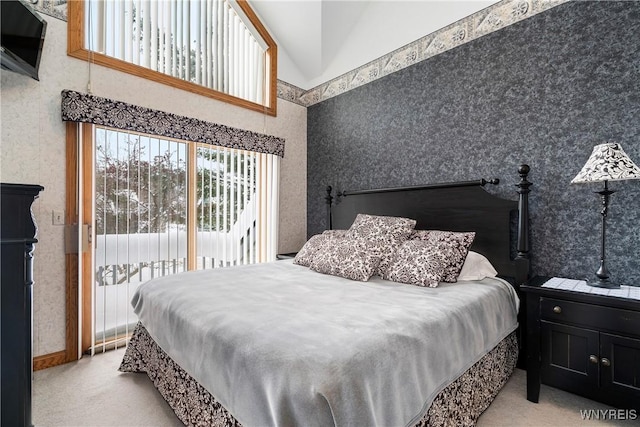 carpeted bedroom with access to exterior and lofted ceiling