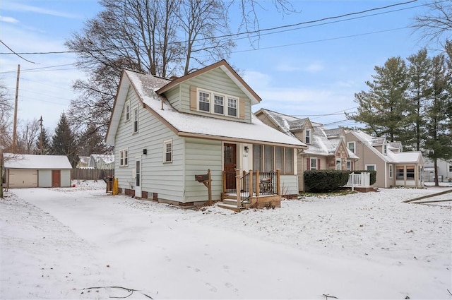 bungalow-style house with central air condition unit, an outdoor structure, and a garage