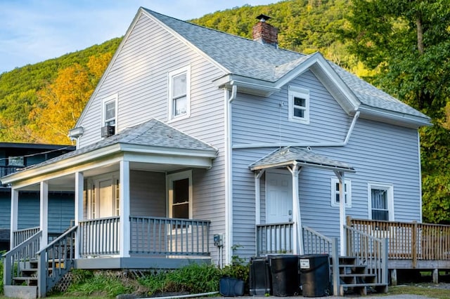 back of property with covered porch